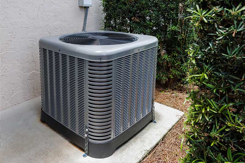 Outdoor AC condenser securely installed on a concrete base in Atlanta, GA