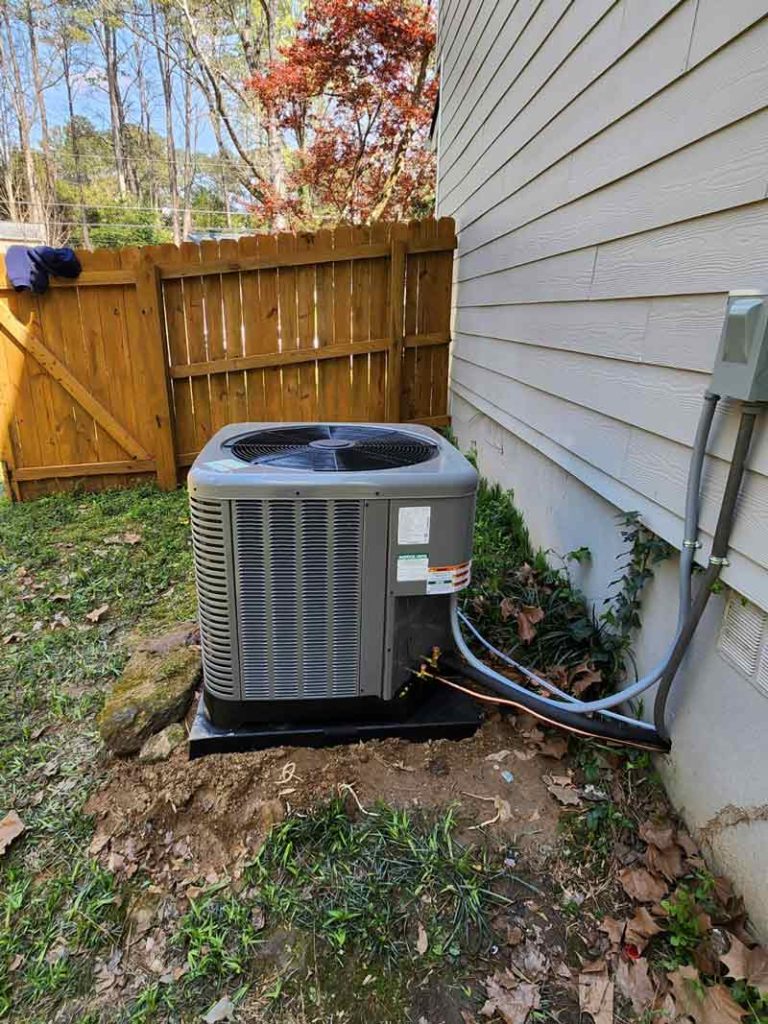 Outdoor AC unit installed beside home by Hope Heating & Air