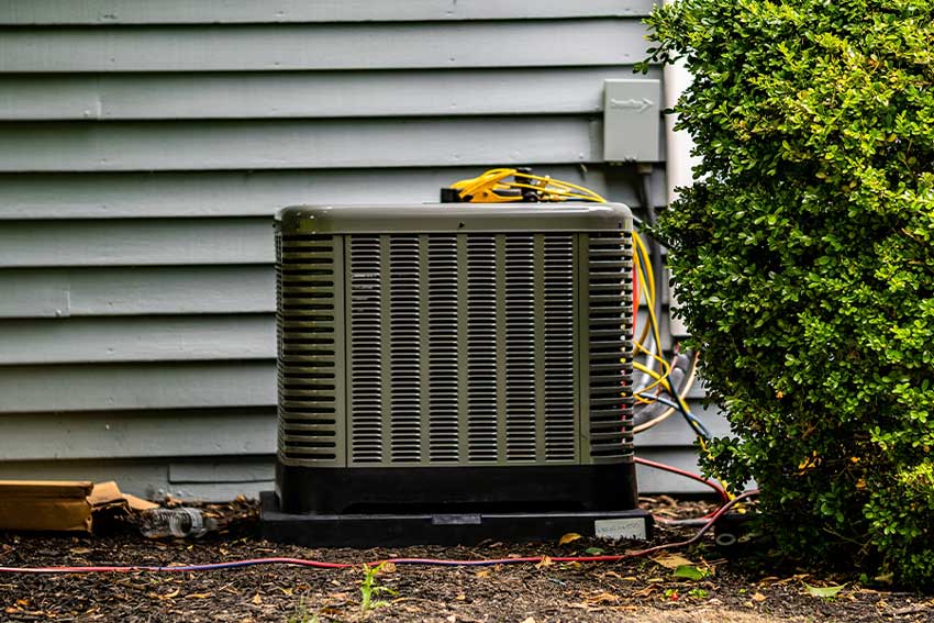 Residential AC condenser being serviced as part of an AC tune-up